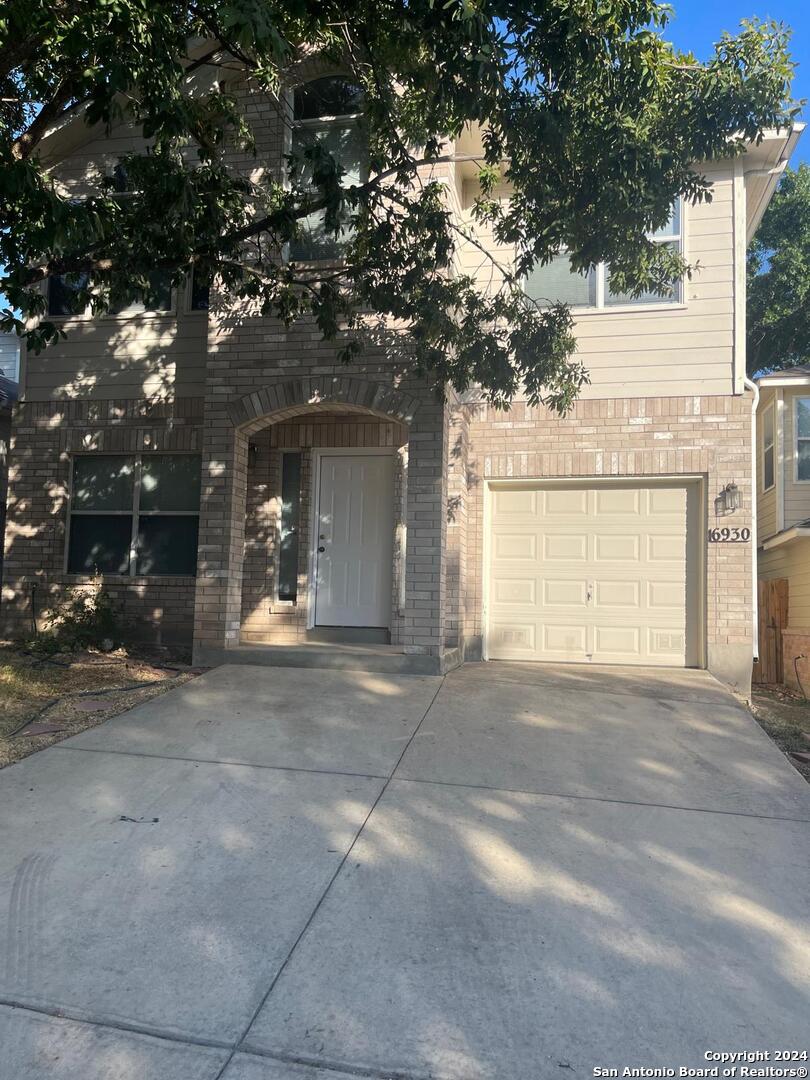 a view of a house with a yard and garage