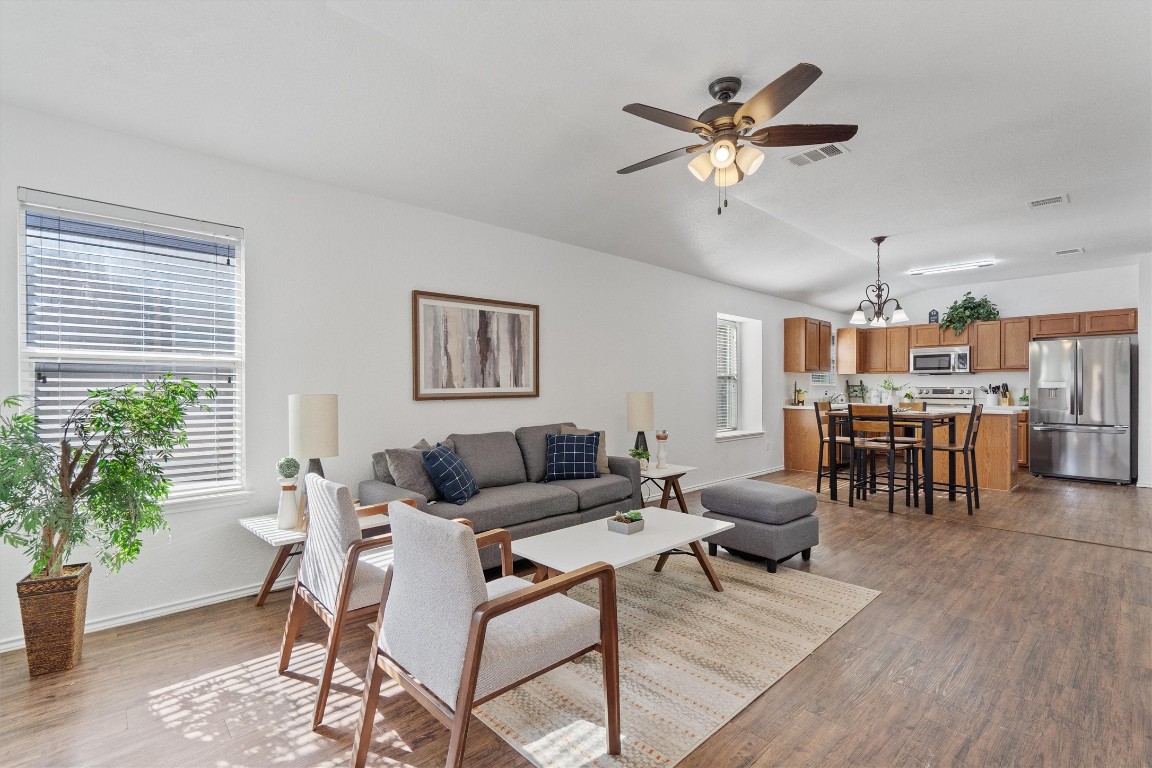 a living room with furniture and kitchen view