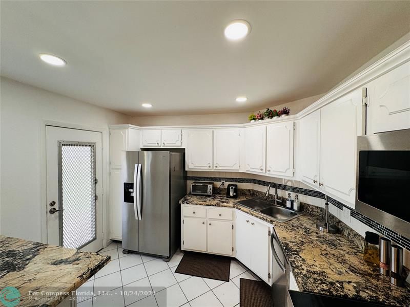 a kitchen with a refrigerator stove and cabinets