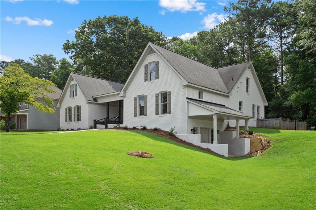 a front view of house with yard and green space