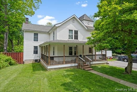 a view of a house with a yard and sitting area