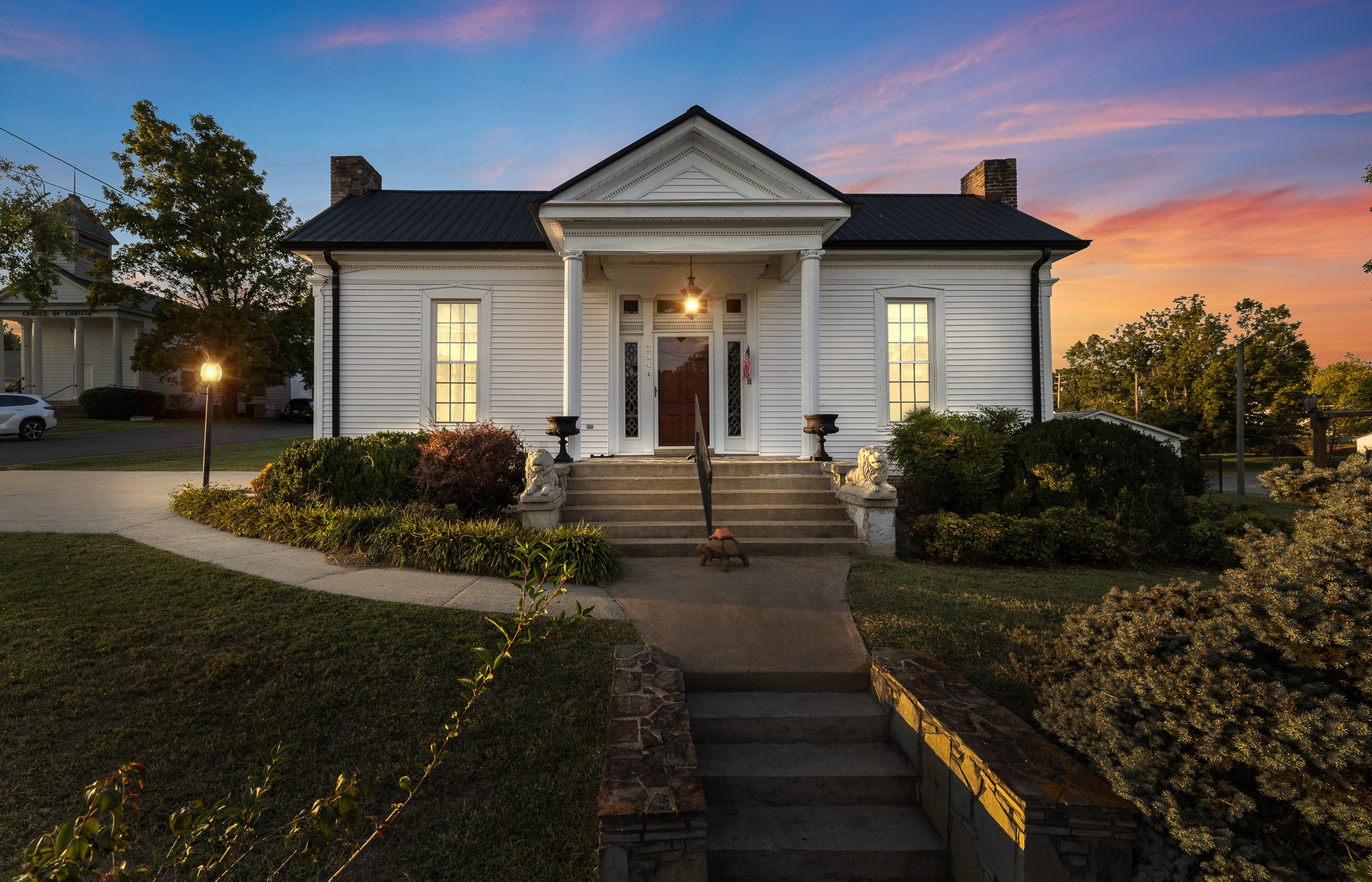 a front view of a house with garden