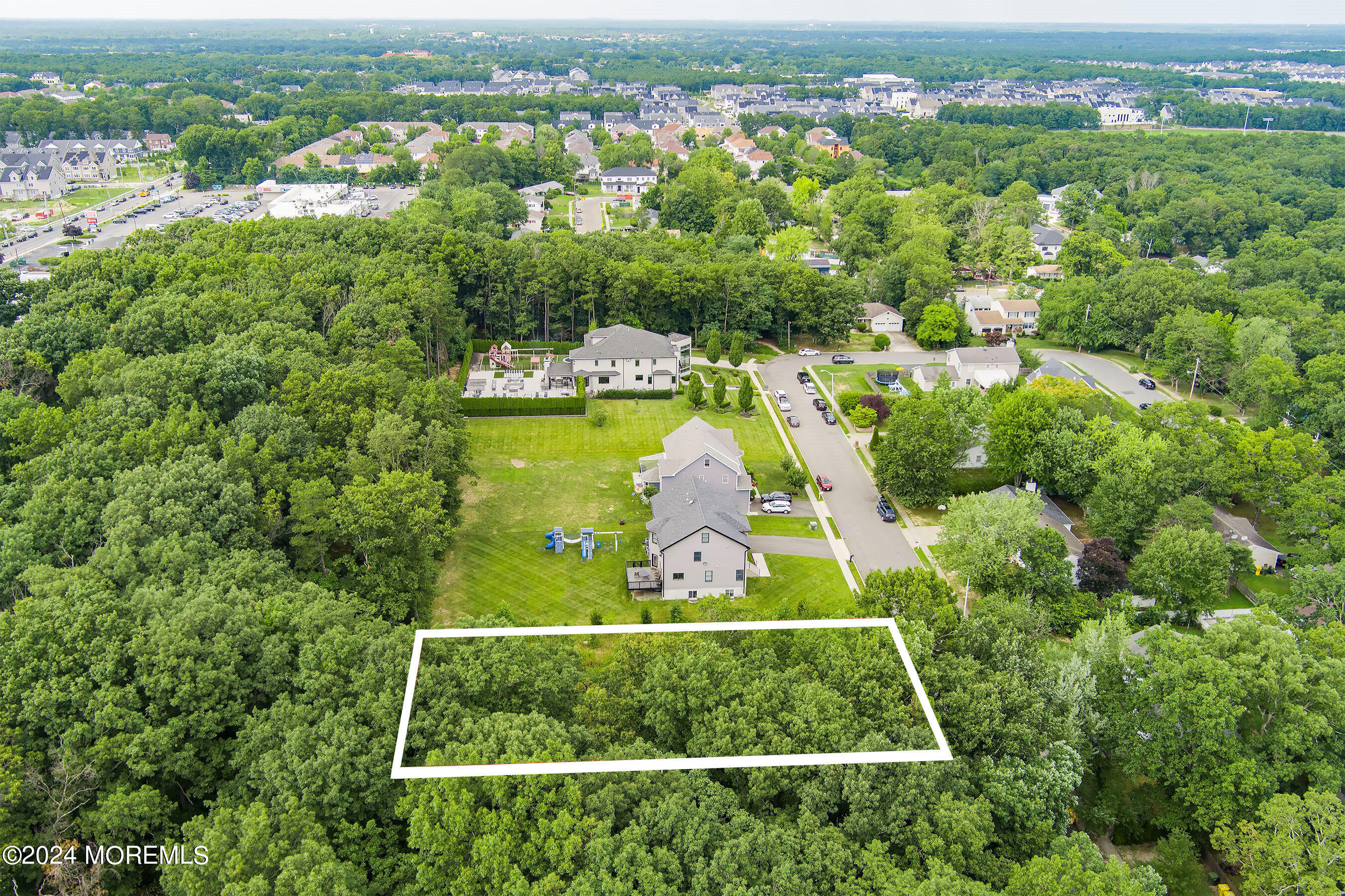 an aerial view of residential houses with outdoor space and swimming pool