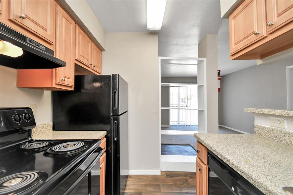 a kitchen with stainless steel appliances granite countertop a stove and a refrigerator