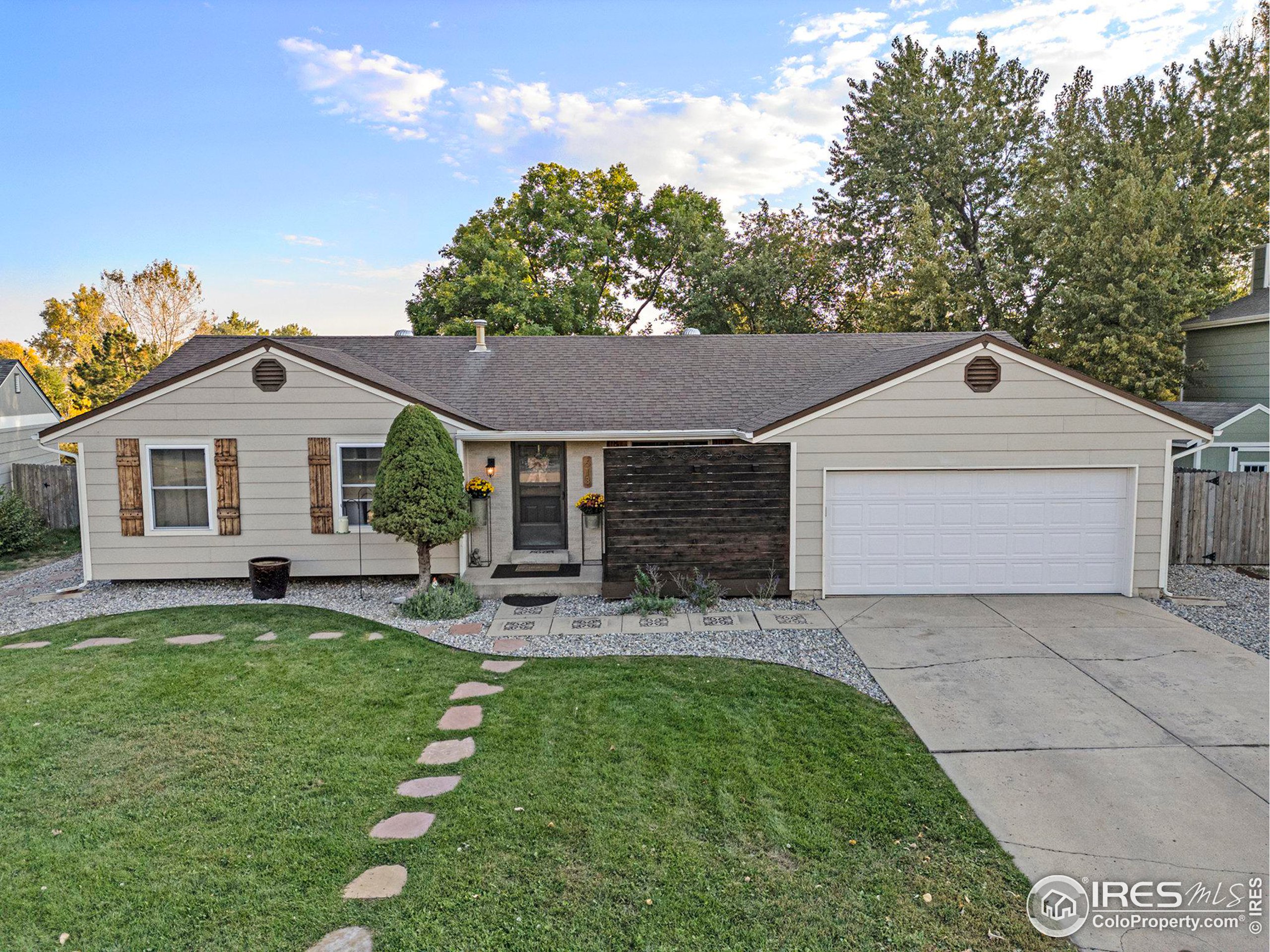 a front view of a house with a yard and outdoor seating