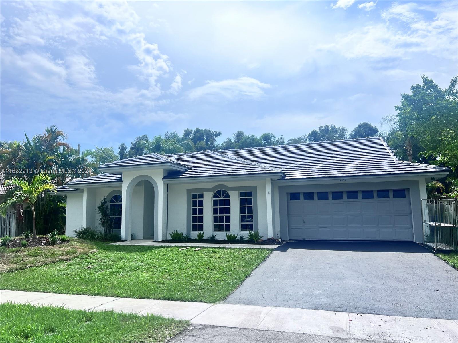 front view of a house with a garden