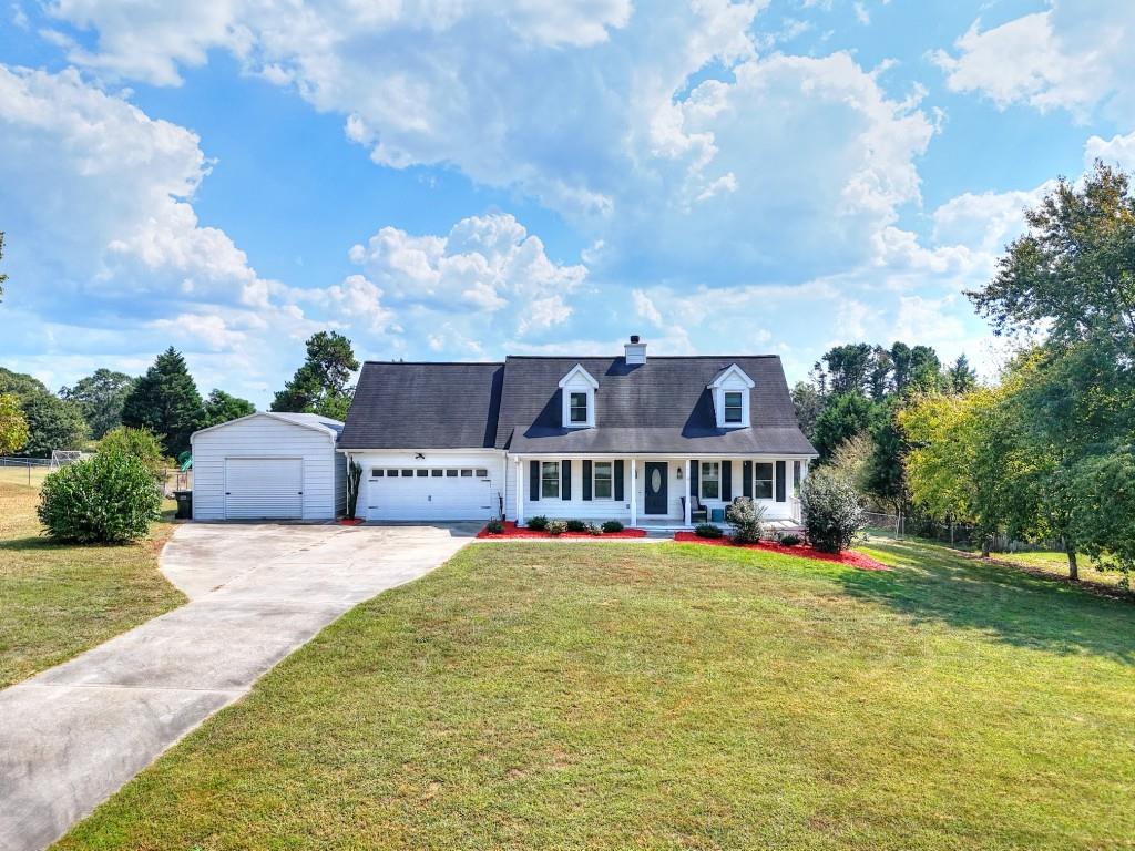 a view of a house with a big yard and large trees