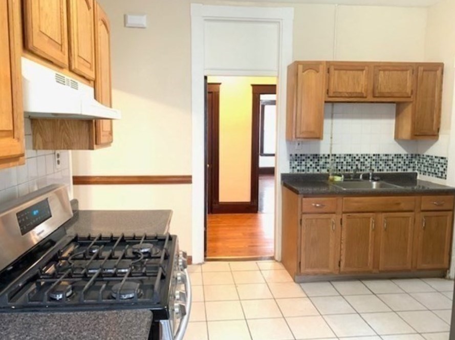 a kitchen with granite countertop a stove and a refrigerator