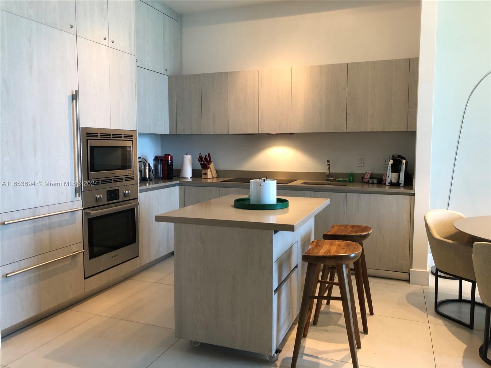 a kitchen with a stove a sink and a refrigerator