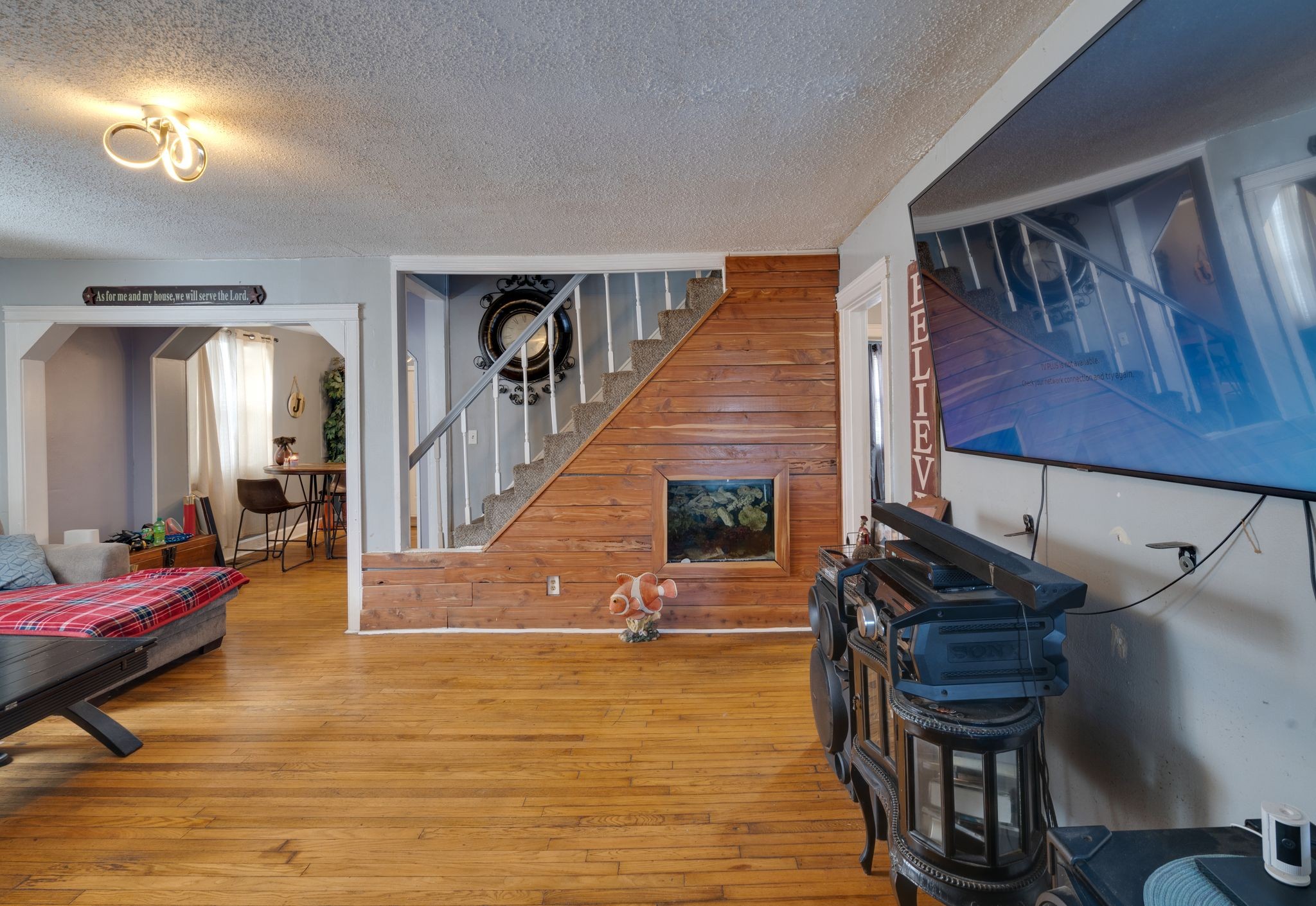 a living room with furniture and a wooden floor