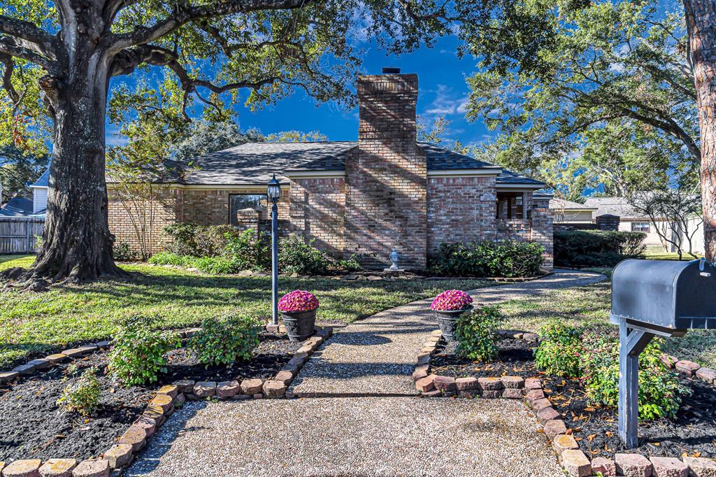 A charming renovated one-story home, nestled in a hidden cul-de-sac with lush landscaping and an inviting front entry.