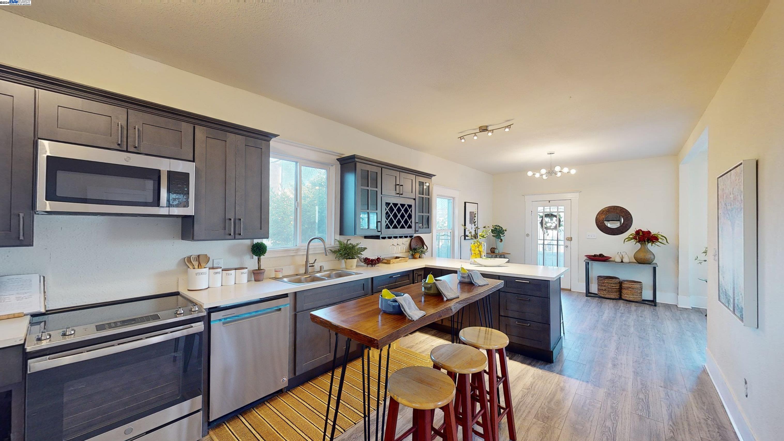 a kitchen with a sink appliances and cabinets