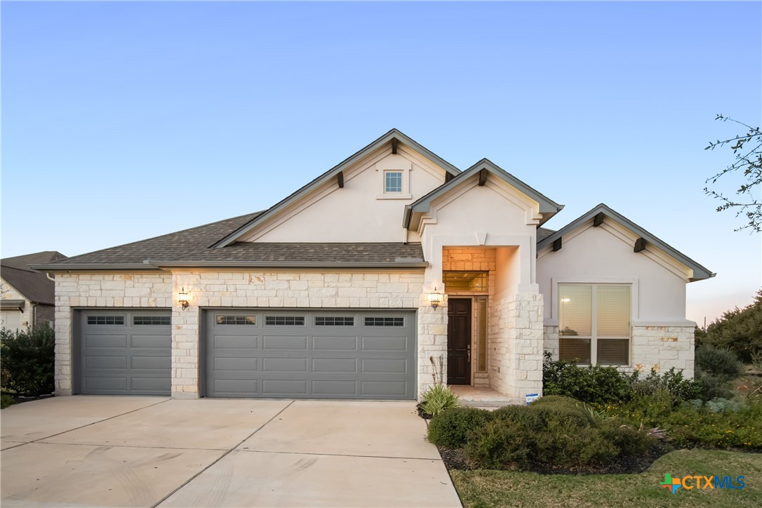 a front view of a house with yard and garage