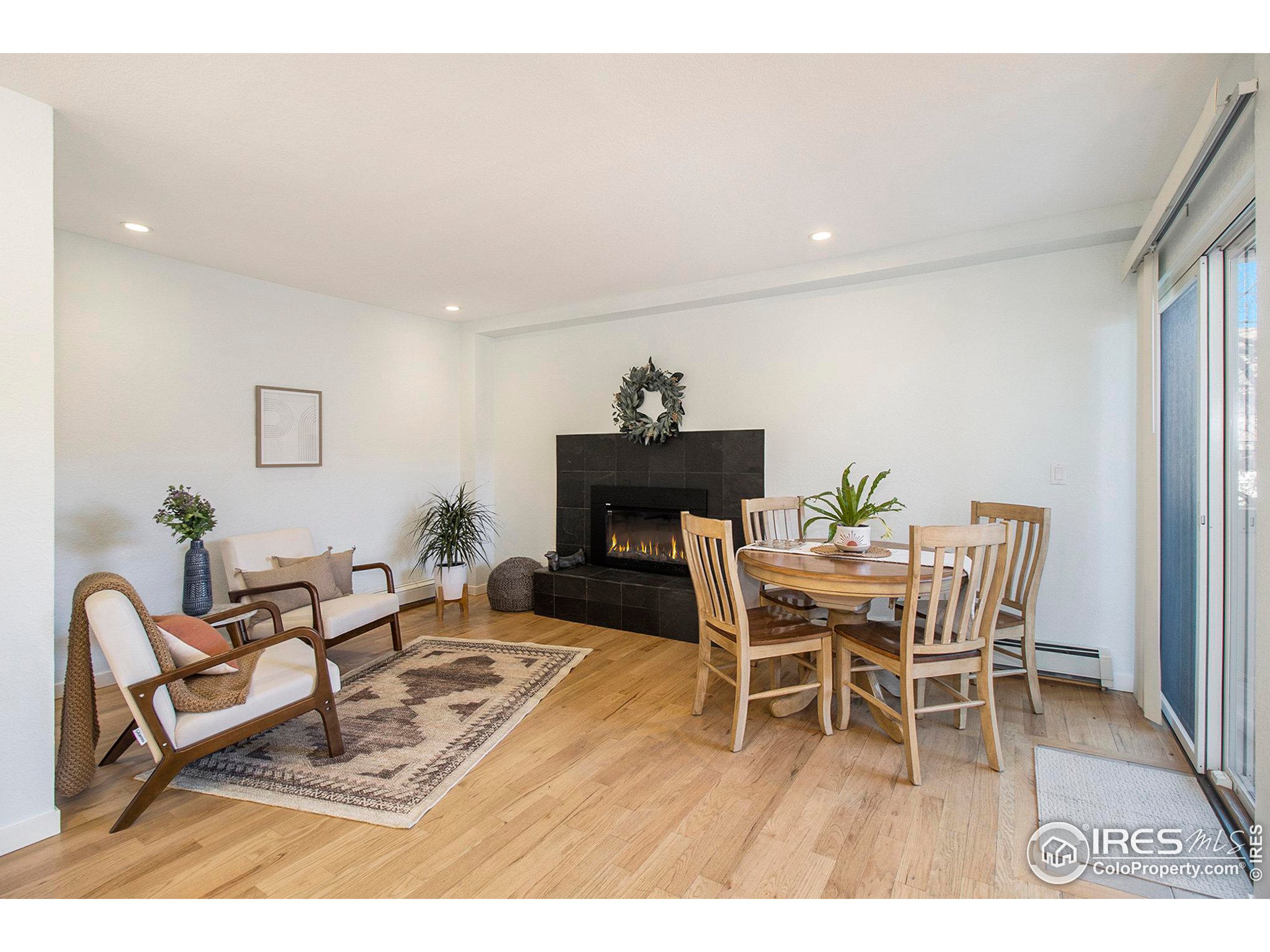 a dining room with furniture a rug and wooden floor