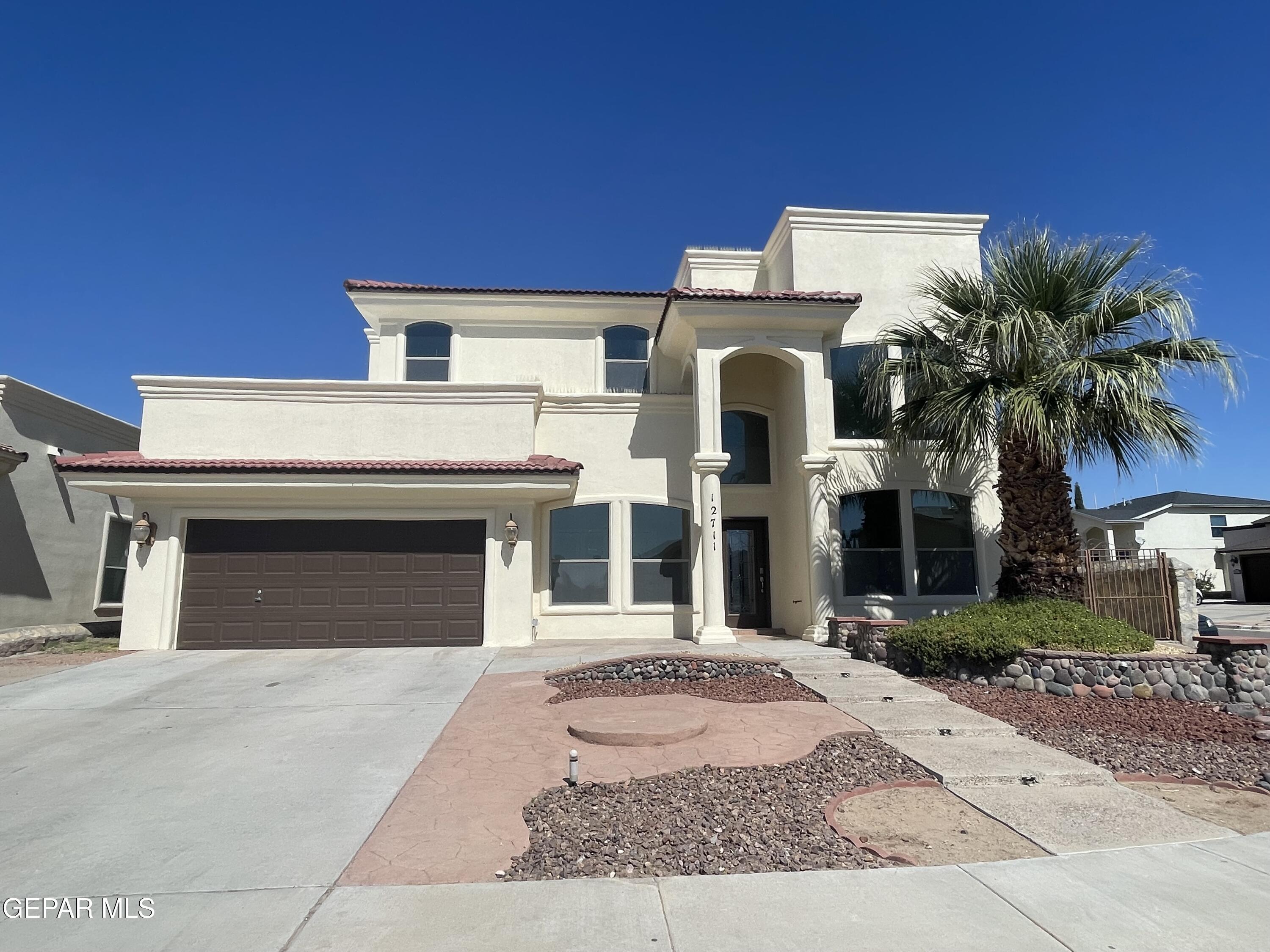 a view of a house with a yard and garage