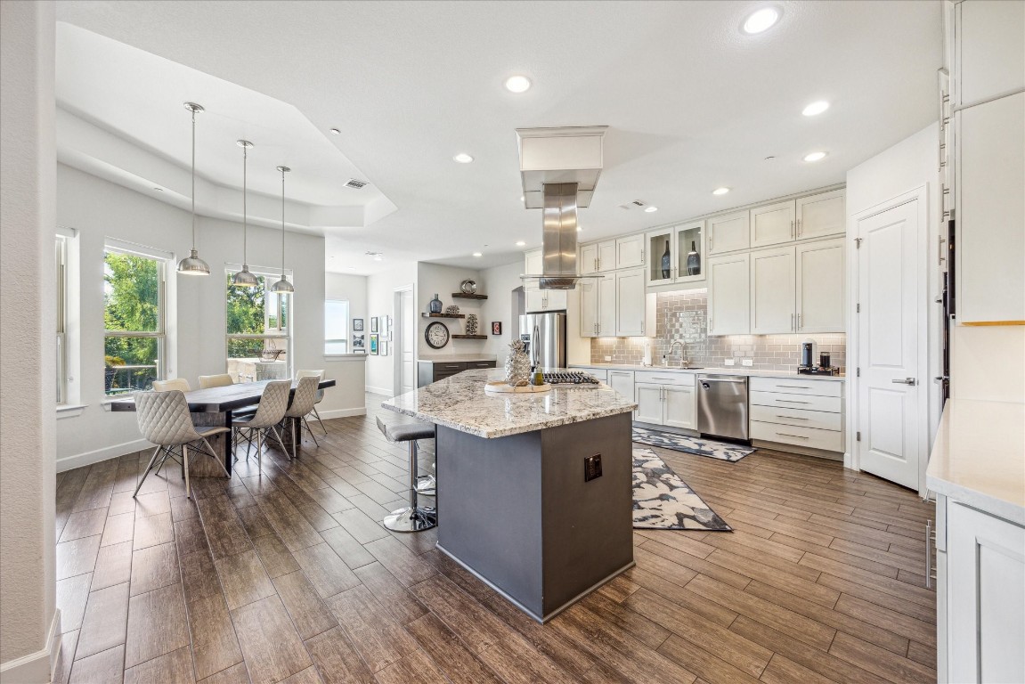 a large kitchen with cabinets and wooden floor