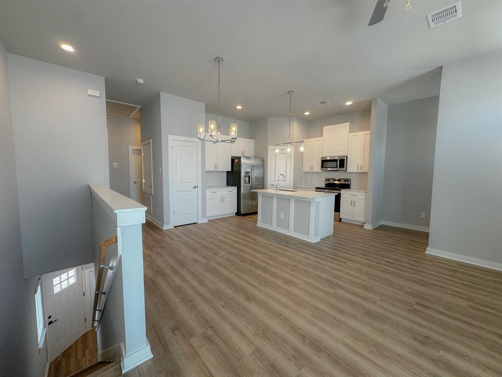 a view of kitchen and wooden floor