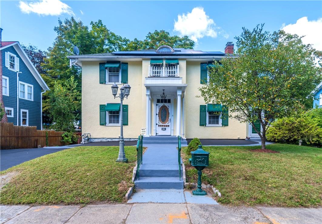 a front view of a house with garden