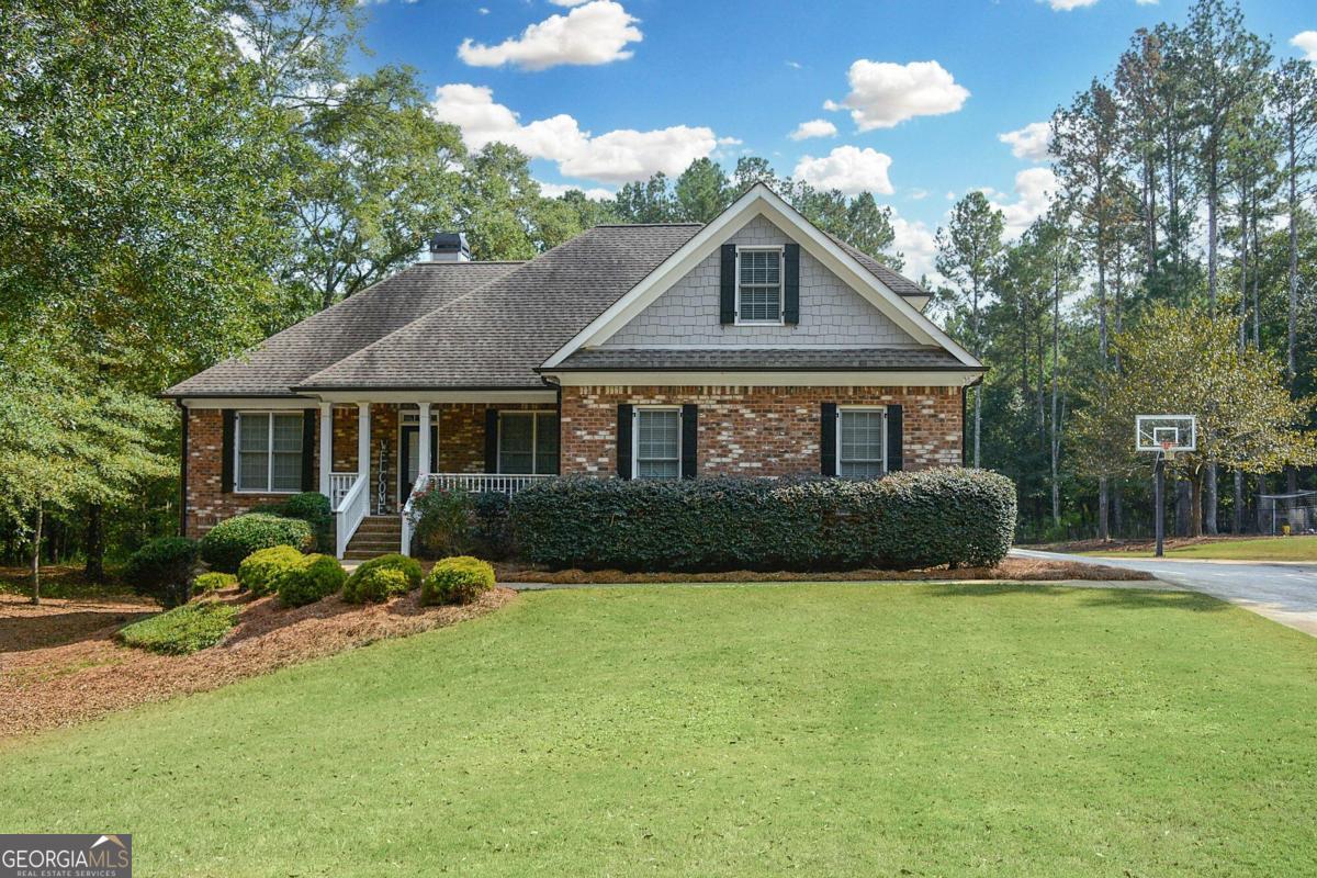 a front view of a house with a yard and porch