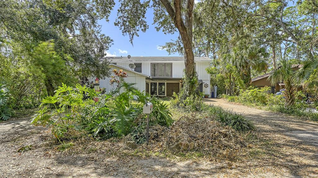 a view of a house with a tree