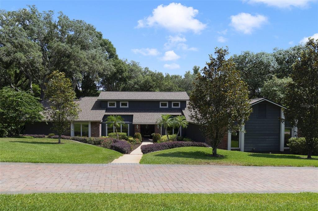 a view of house with a yard