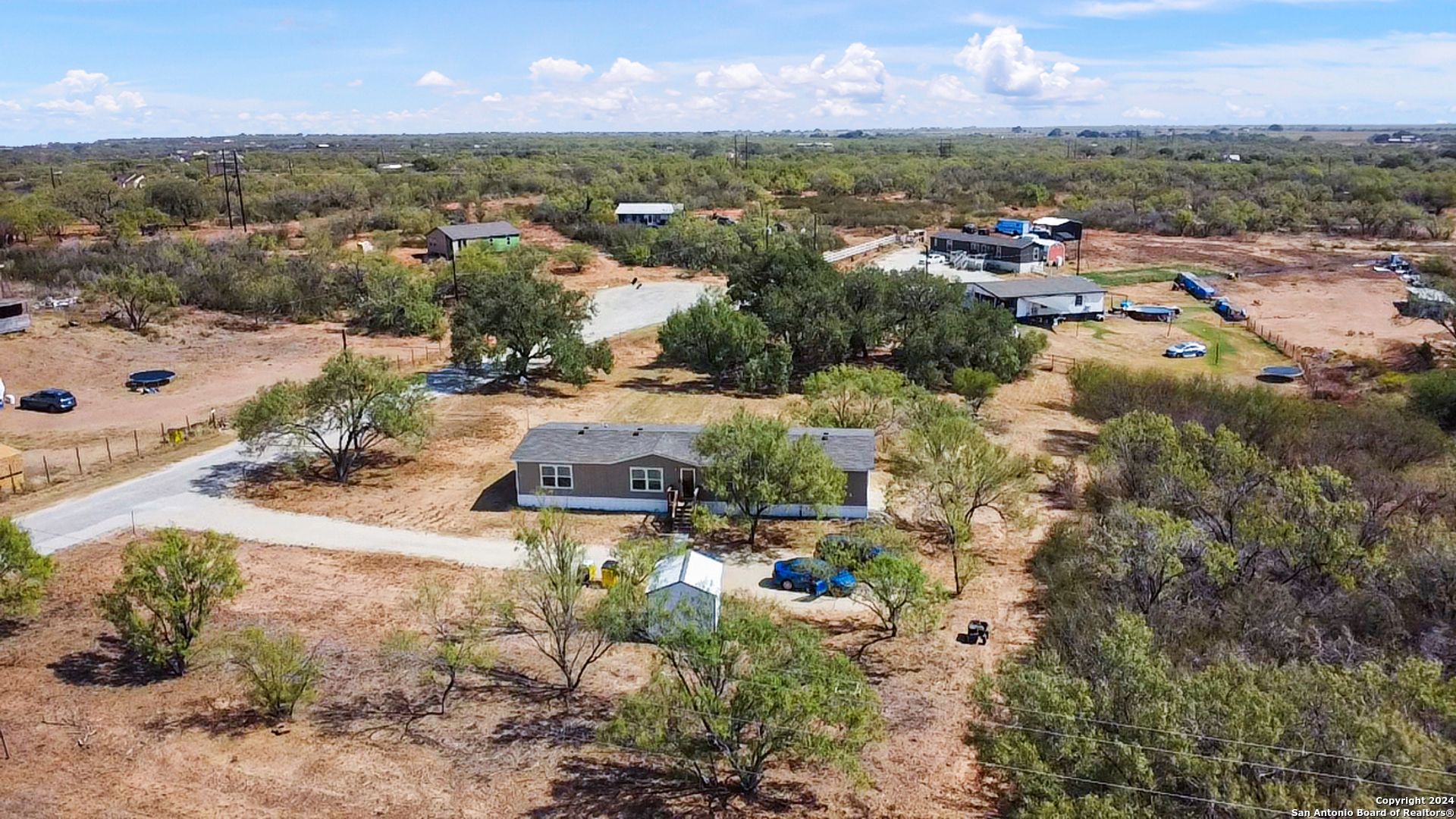 an aerial view of a houses with a swimming pool