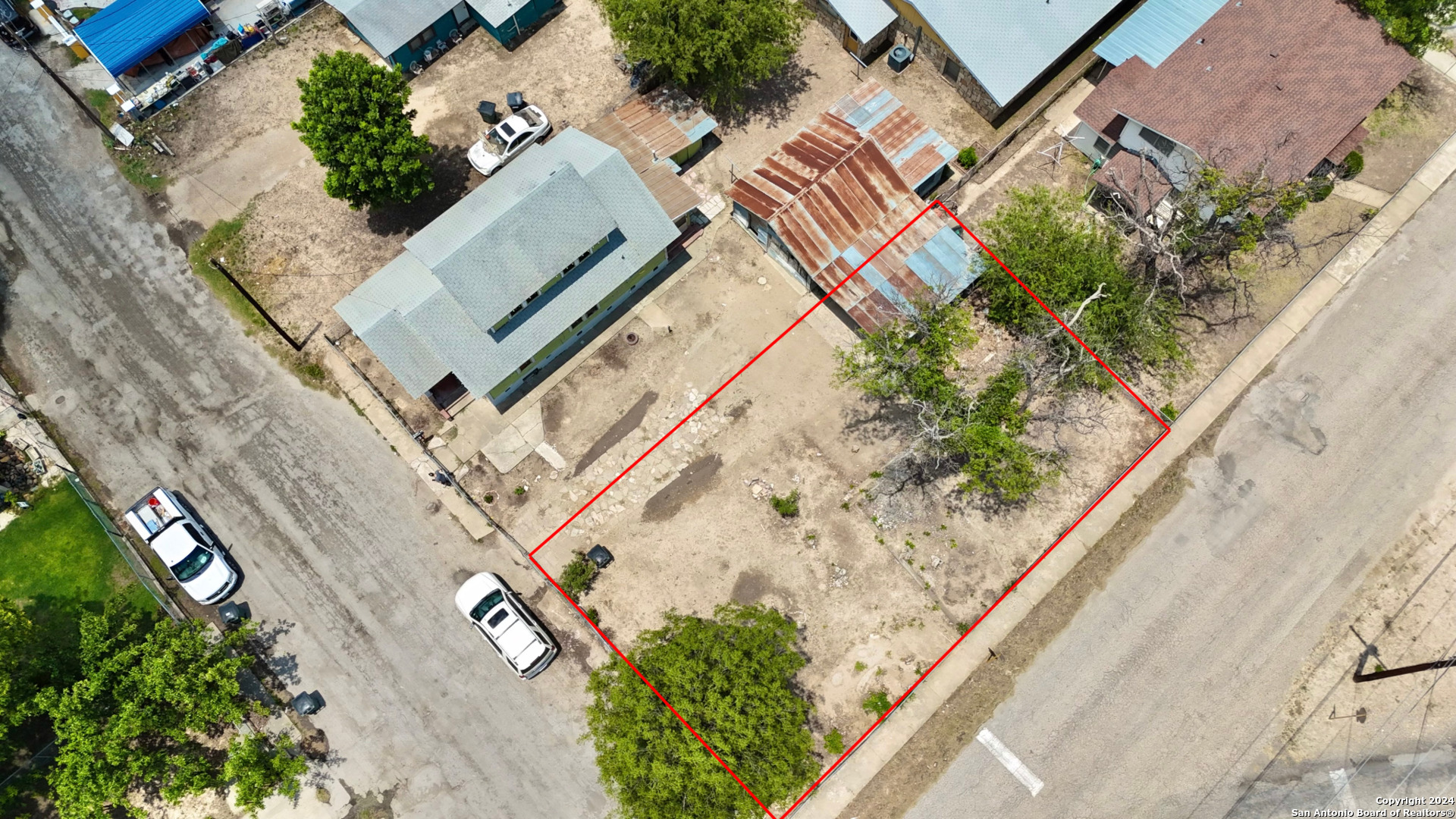 an aerial view of a house with a yard and potted plants