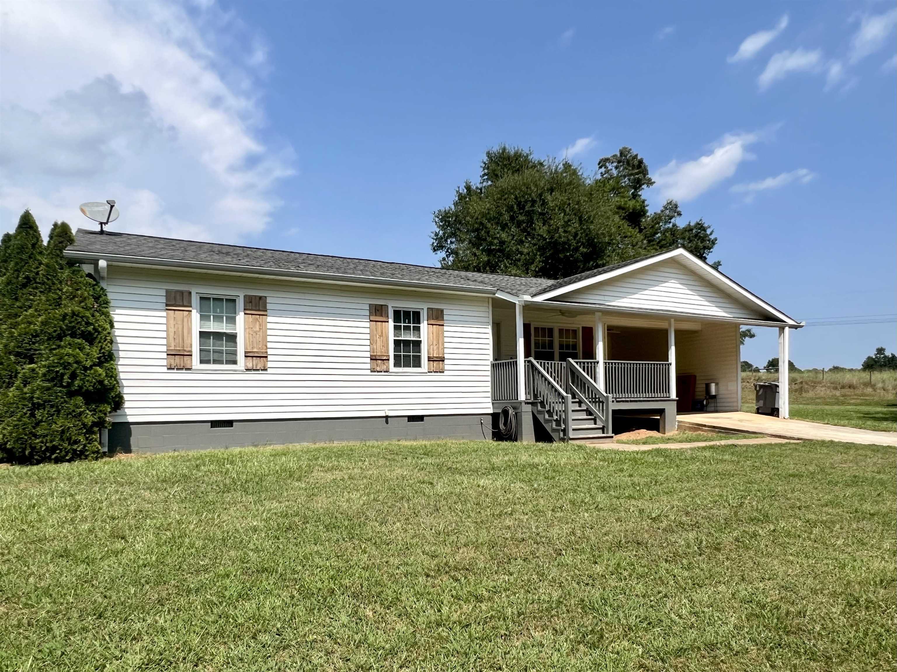 a front view of house with yard and seating area