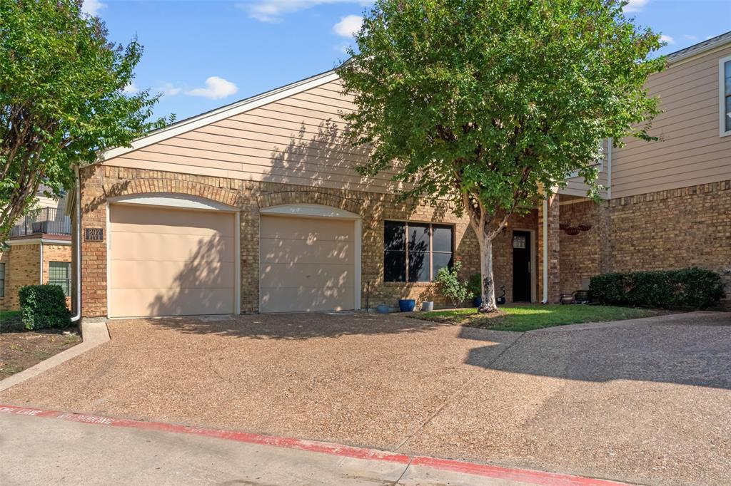 a view of a house with a patio and a garage