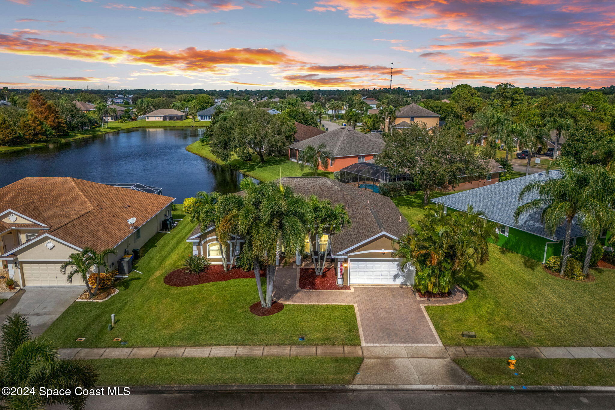 an aerial view of residential houses with outdoor space and river