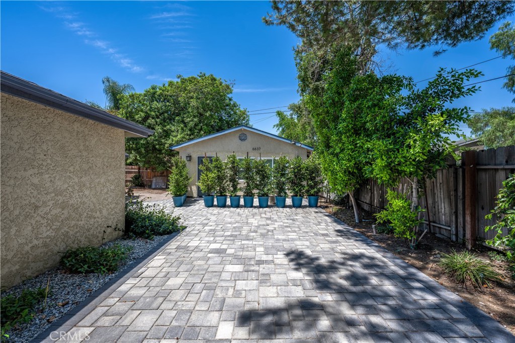 a view of backyard with a garden and trees