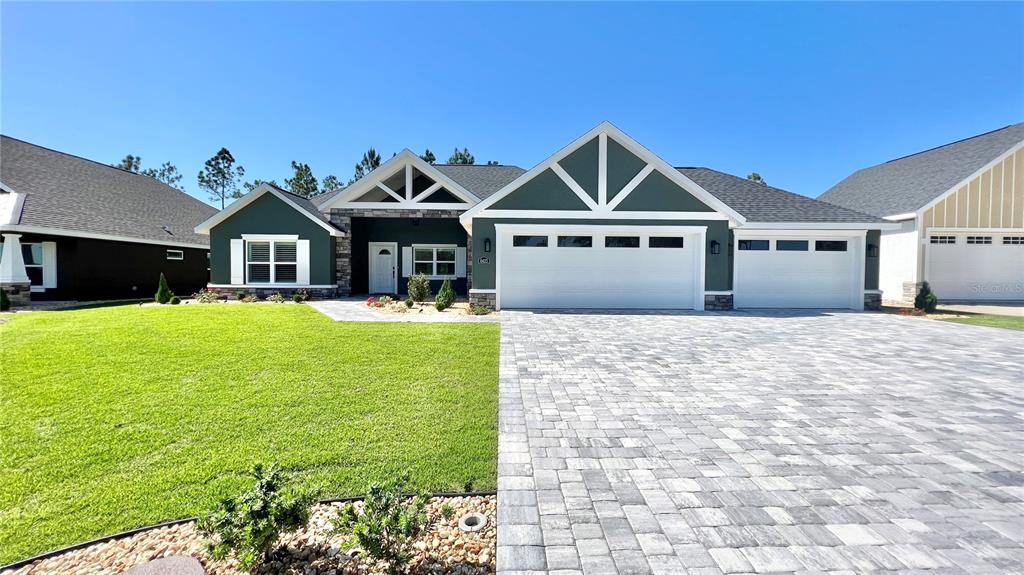 a front view of a house with yard and green space