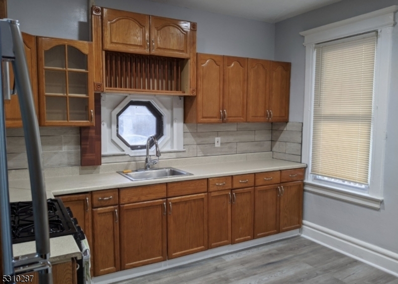 a kitchen with a sink a cabinets and window