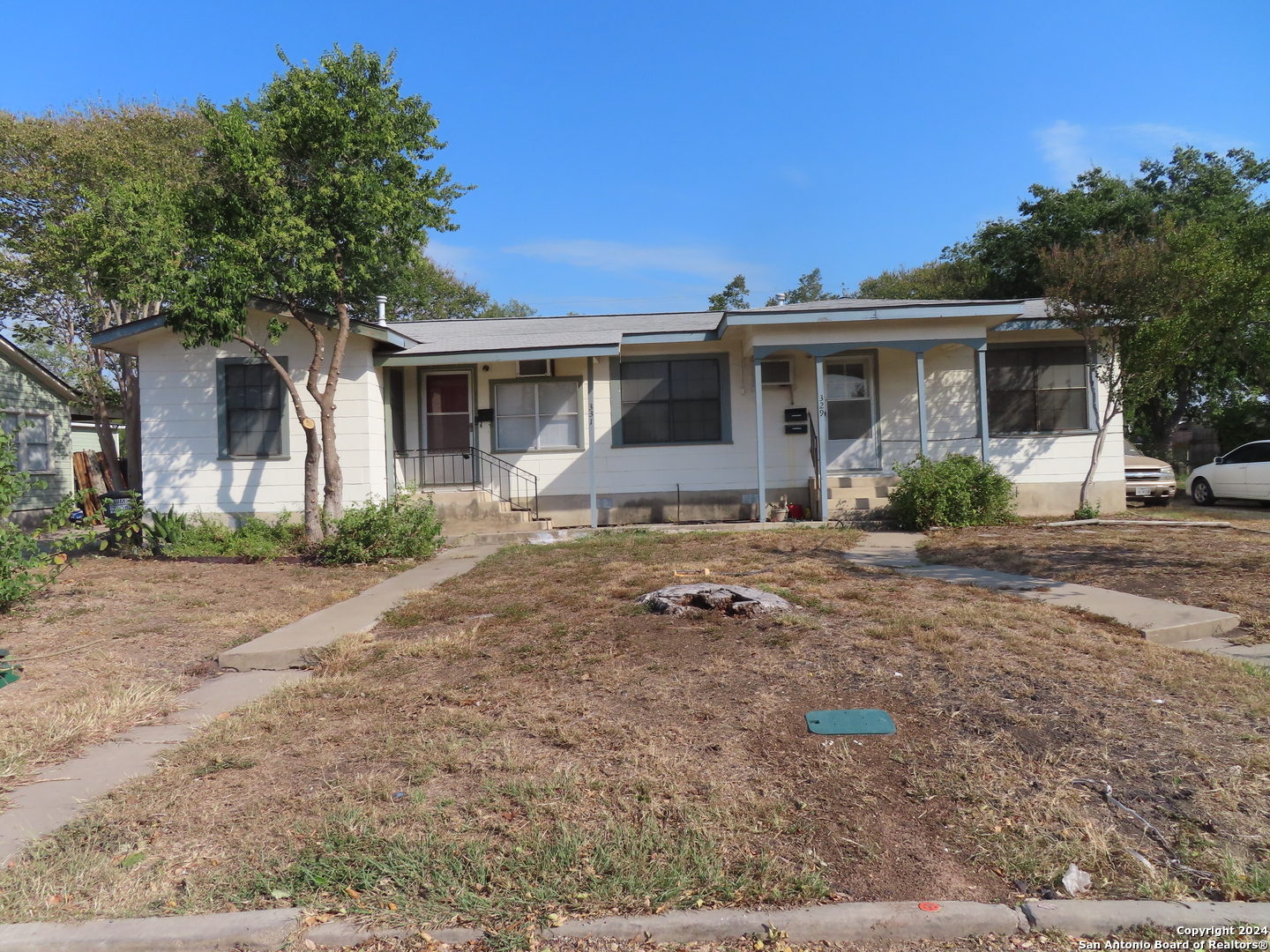 a front view of a house with garden