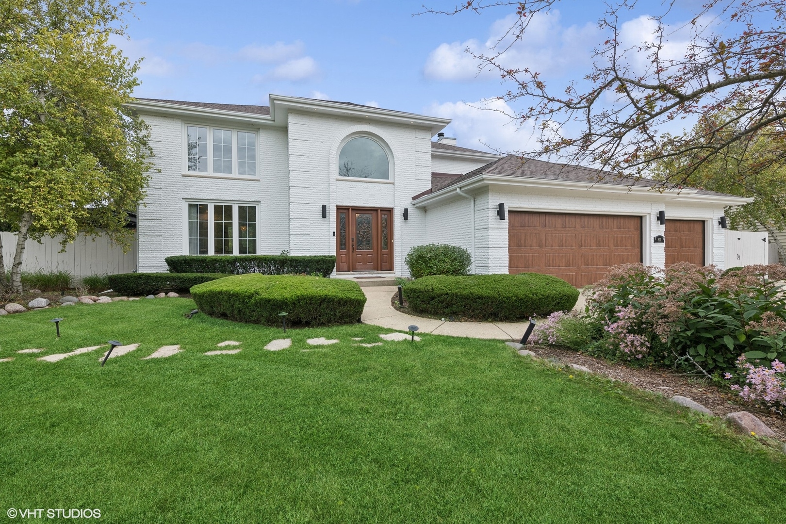 a front view of house with yard and green space