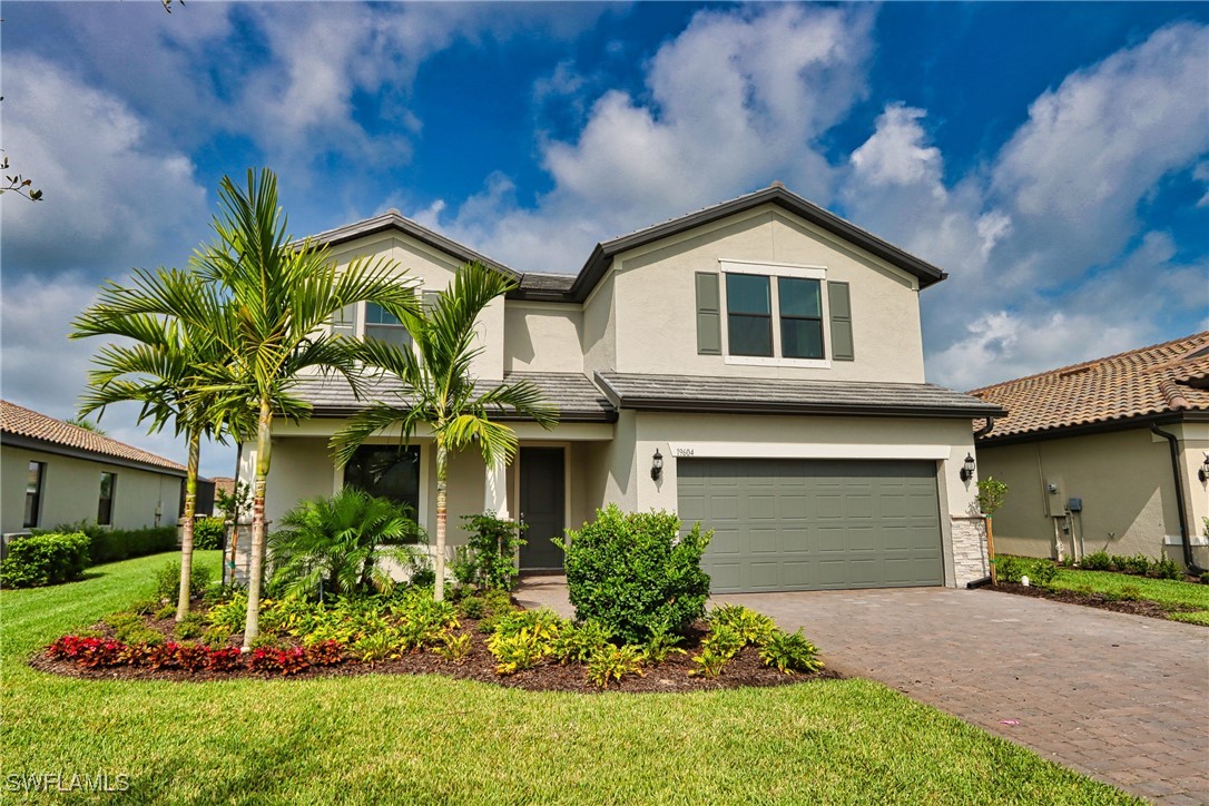 a front view of a house with a yard and garage