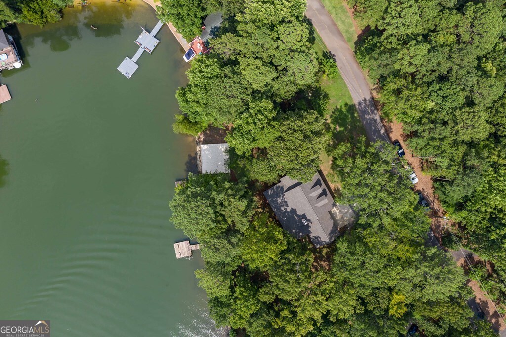 an aerial view of a house with a yard and garden