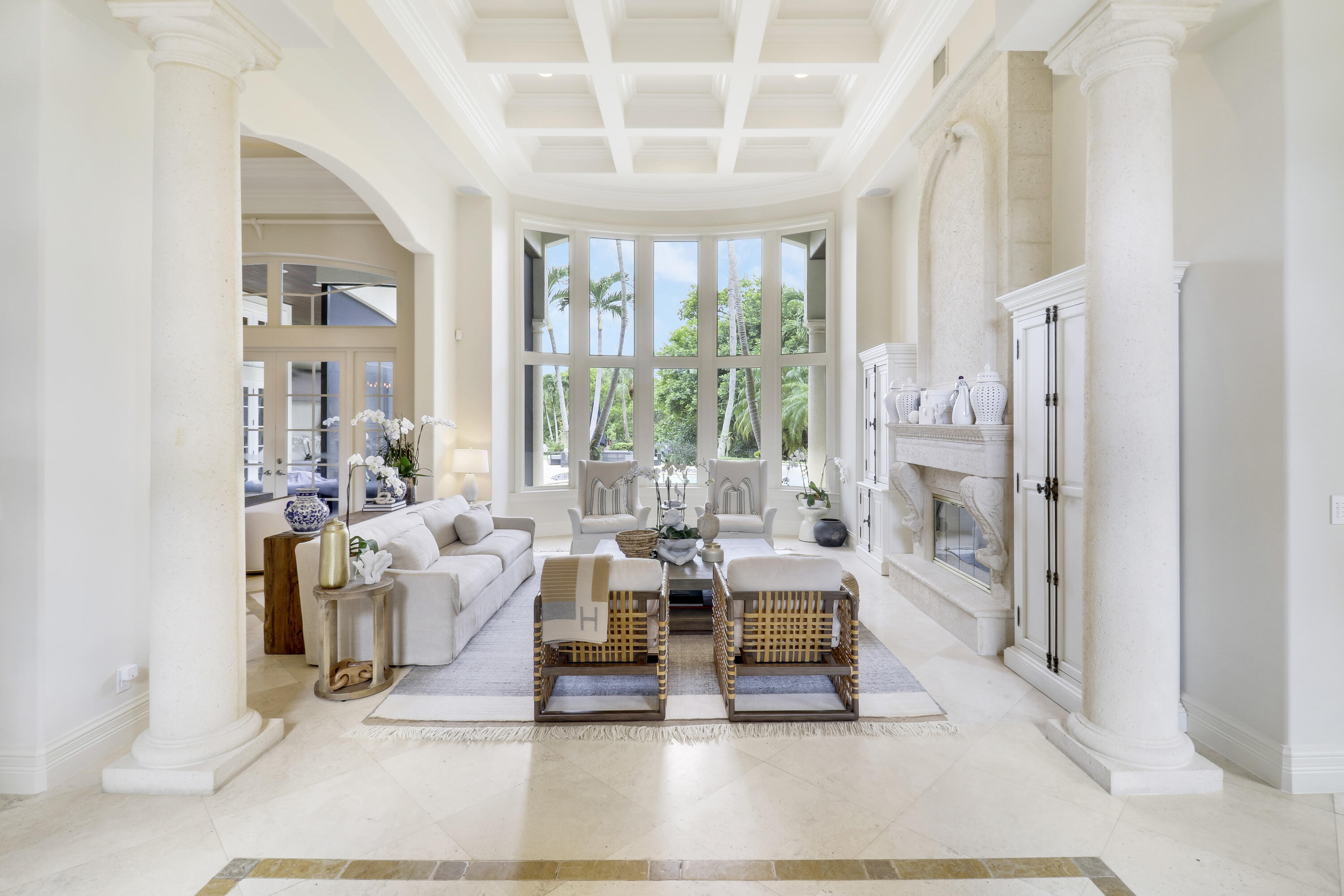 a living room with furniture large window and a table