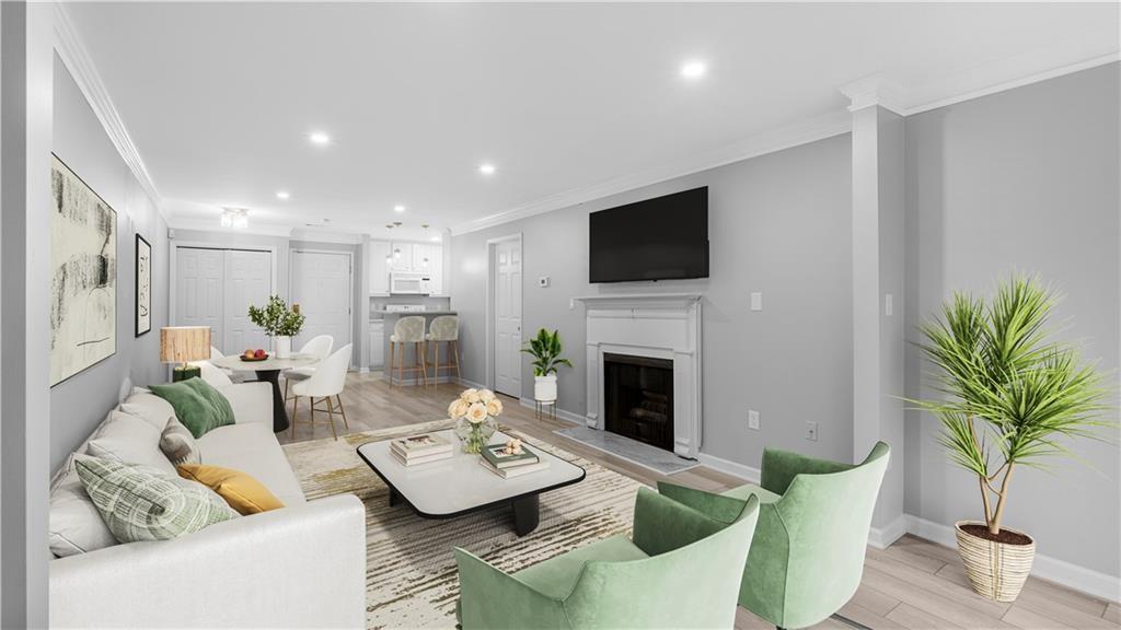 a living room with furniture a fireplace and a potted plant