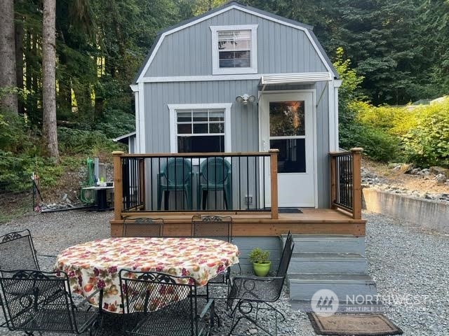 a front view of house with yard outdoor seating and barbeque oven