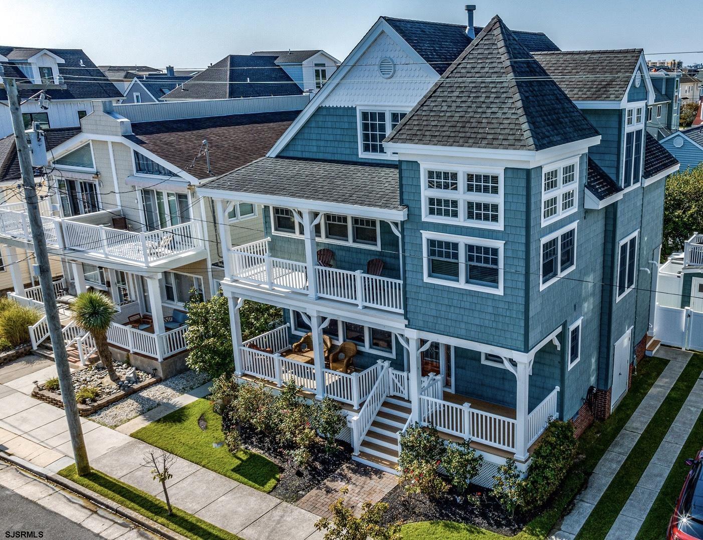 an aerial view of a house with yard porch and sitting area