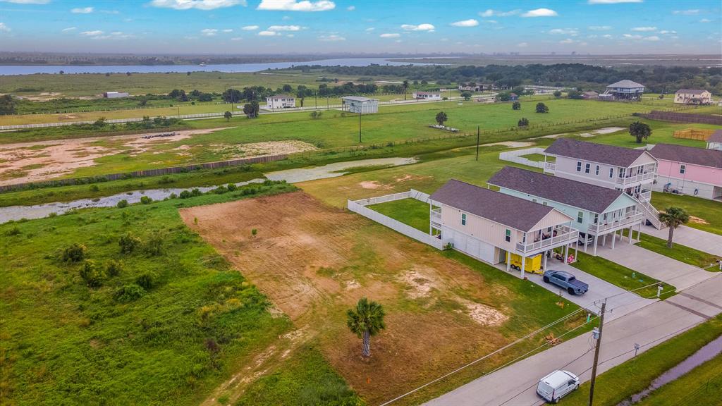 an aerial view of residential houses with outdoor space and lake view