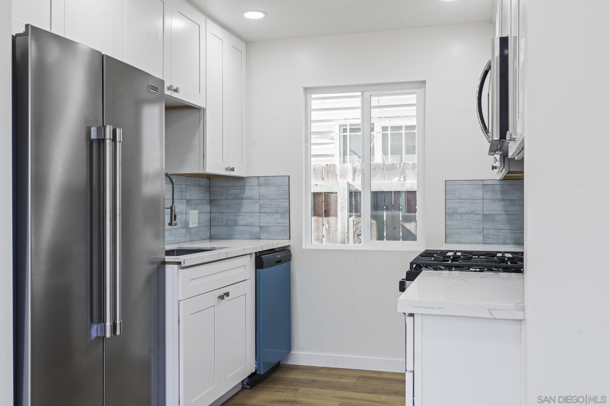 a kitchen with a refrigerator and a stove