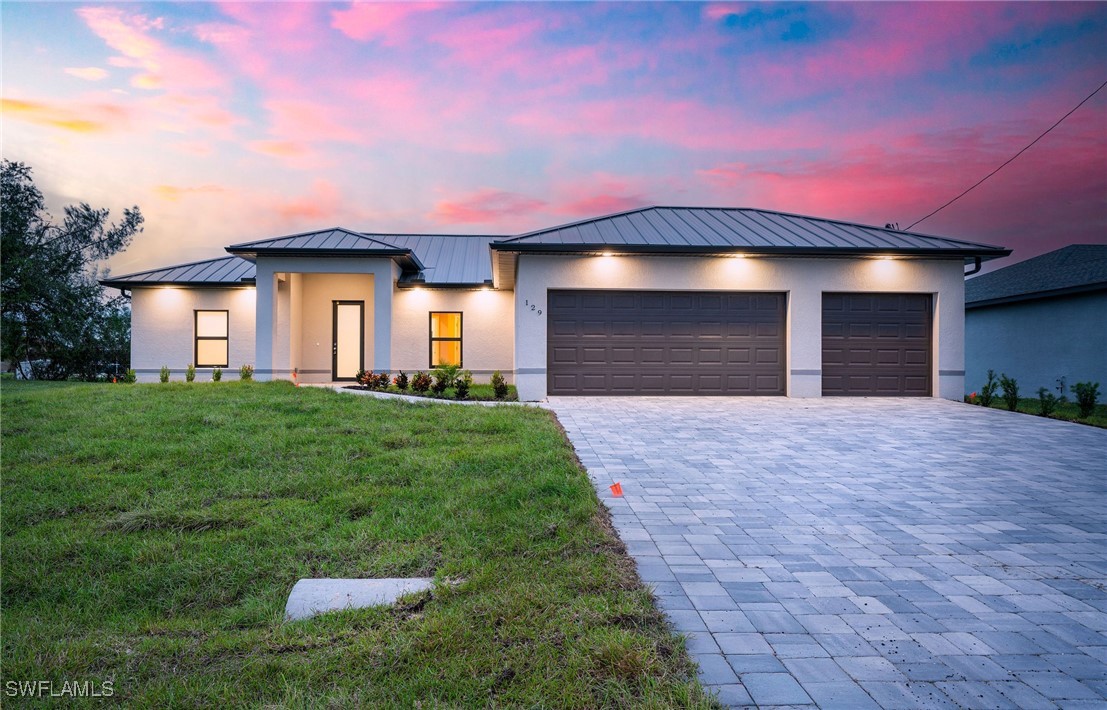 a front view of a house with a yard and garage