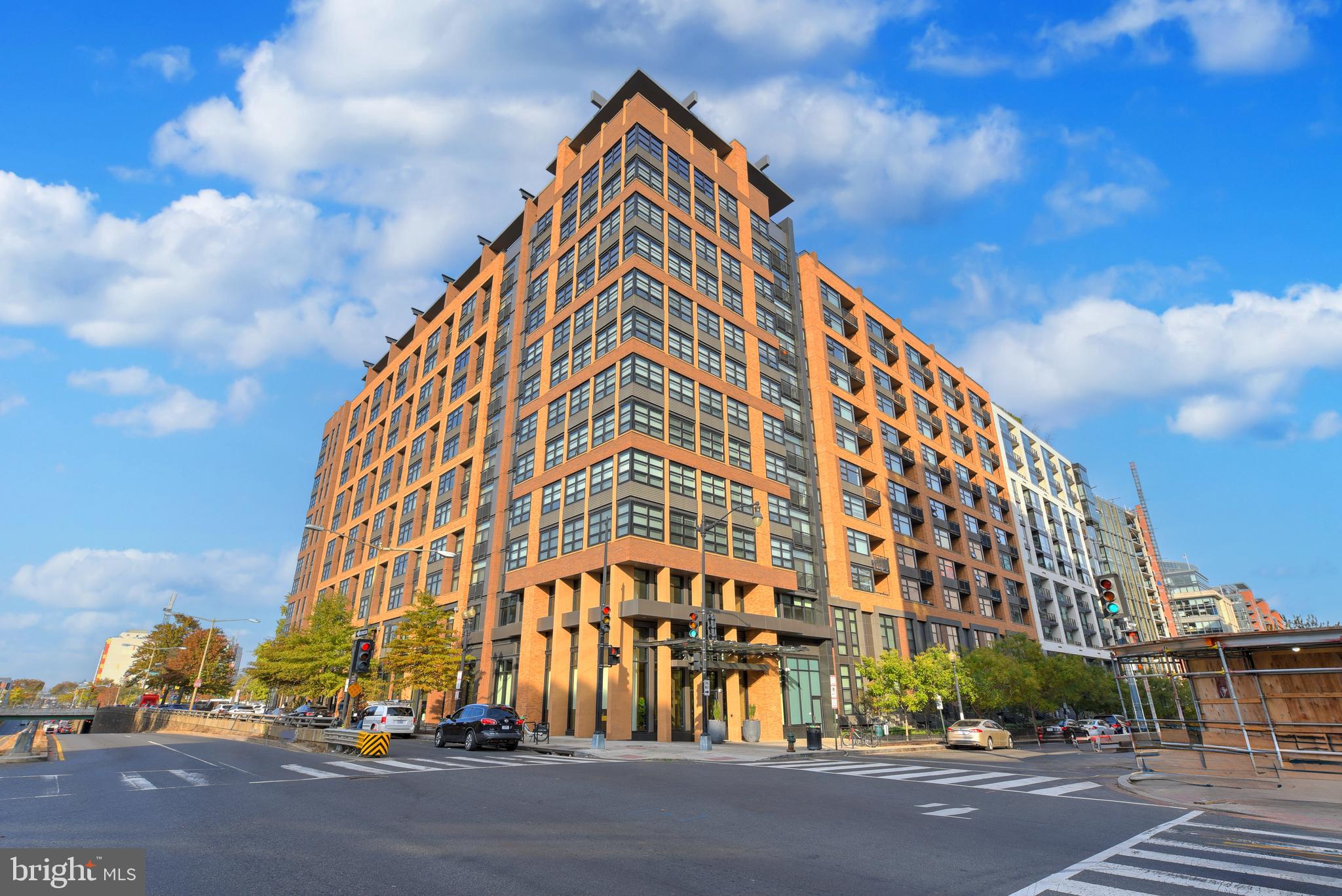 a view of a tall building next to a road