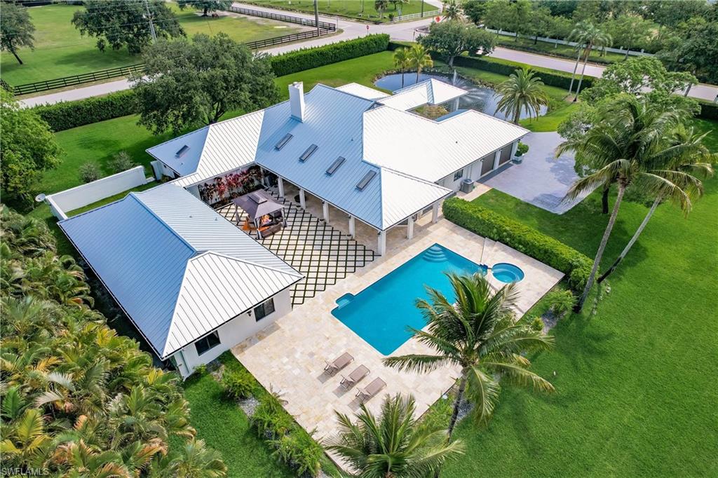 an aerial view of a house with a yard and trees