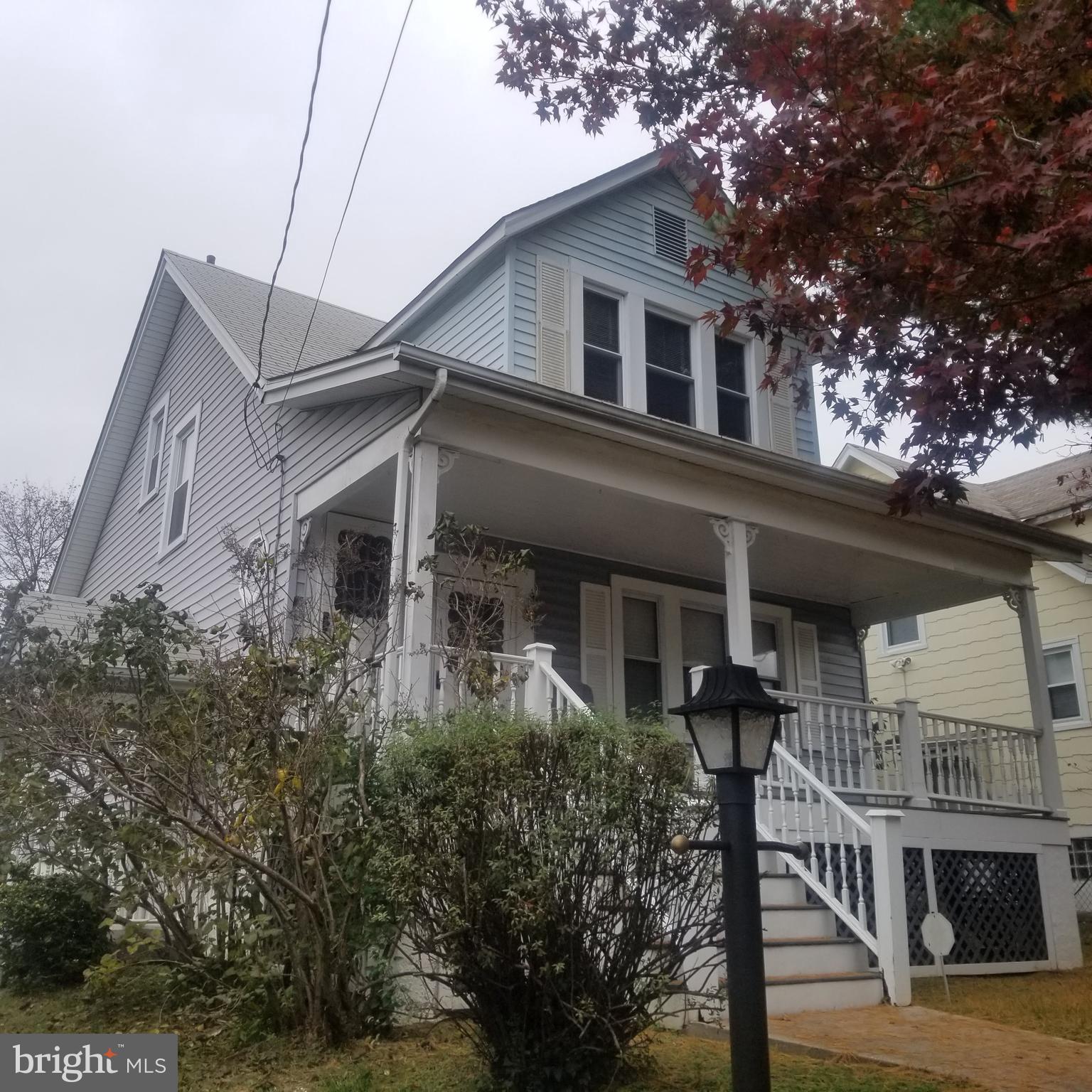 a front view of a house with plants