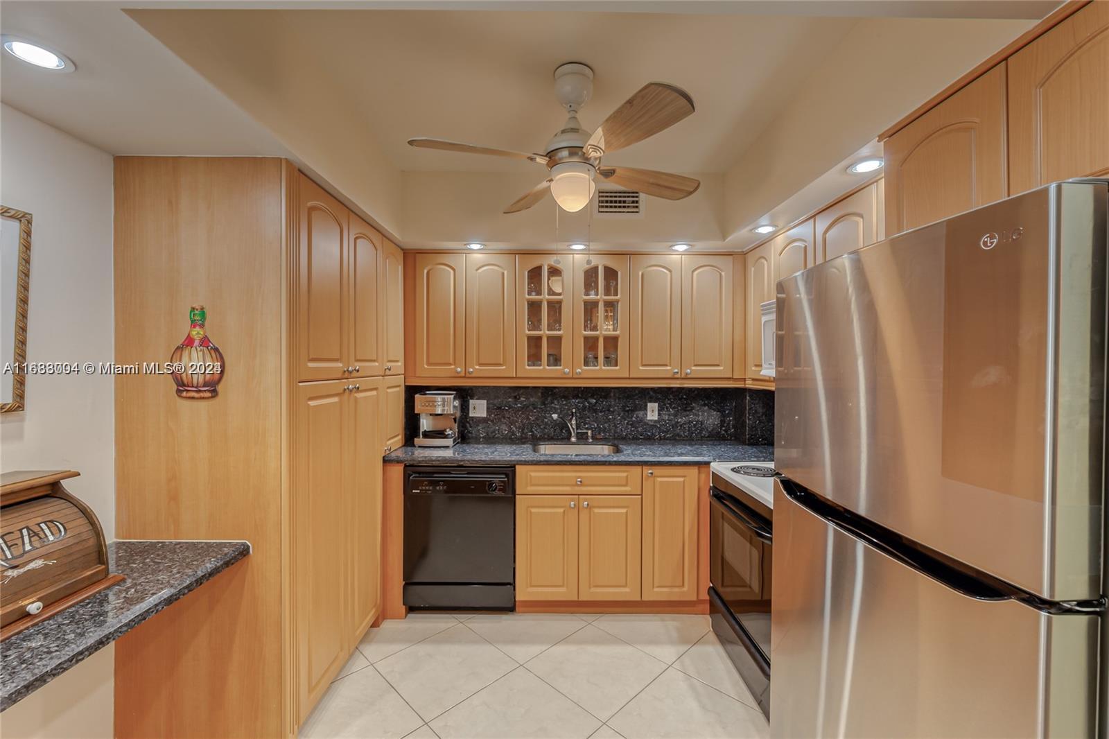 a kitchen with stainless steel appliances granite countertop a refrigerator and a sink