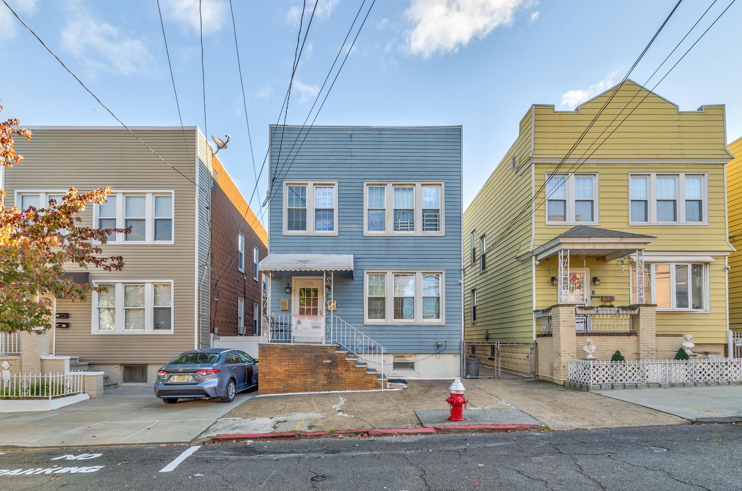 a front view of a residential apartment building with a yard