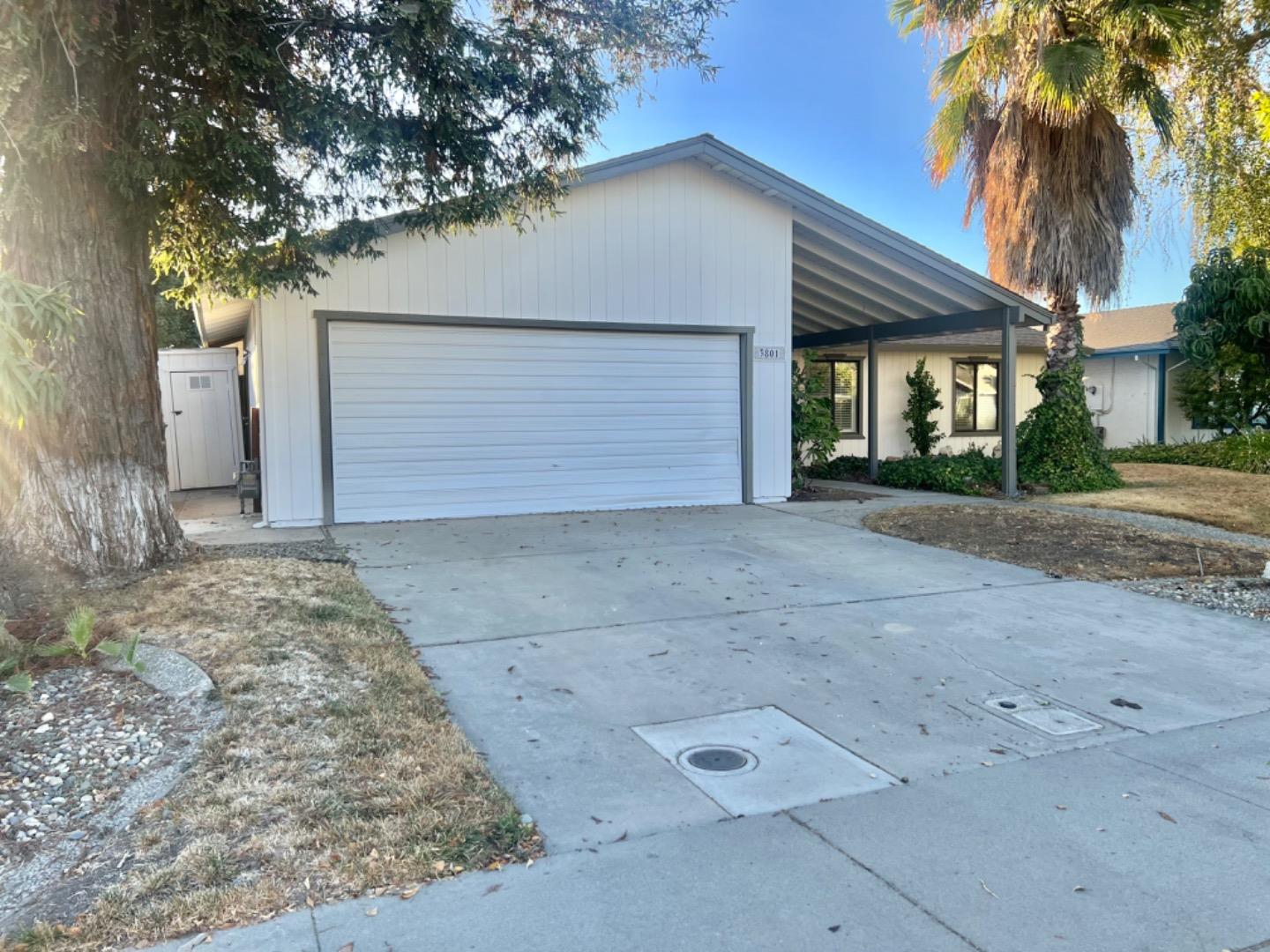 a view of a house with a yard and garage